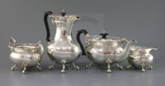 A George V four piece silver tea service set by Gibson & Co, of oval form, with pierced wavy