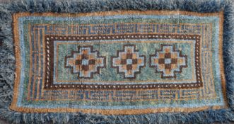 A Tibetan 'Wangden' rug, 20th century, of a type used for seating in Buddhist monasteries, the thick