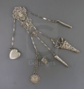 A Victorian silver chatelaine with five suspension chains, hung with thimble case, scissors and