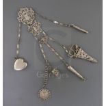 A Victorian silver chatelaine with five suspension chains, hung with thimble case, scissors and