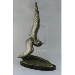 Irene Rochard. An Art Deco bronze model of a seagull flying over a wave, signed in the bronze, on