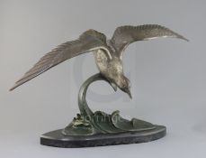 Irene Rochard. An Art Deco bronze model of a seagull flying above waves, signed in the bronze, on
