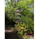 A carved pink granite six tier pagoda garden lantern, Height 10ftViewing by arrangement.