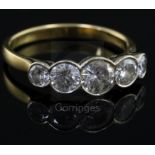 A modern 18ct gold and collet set graduated five stone diamond half hoop ring, size T.