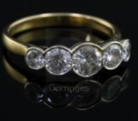 A modern 18ct gold and collet set graduated five stone diamond half hoop ring, size T.