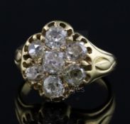 An early-mid 20th century gold and seven stone diamond cluster ring, set with old mine cut stones,