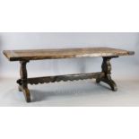 A late 16th century Italian chestnut refectory table, with planked top and trestle underframe, 7ft
