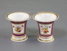 A pair of Rockingham porcelain miniature vases, c.1830, each painted with flower bouquets on a