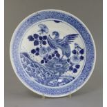 A Chinese blue and white dish, 19th century, painted with an eagle amid flowers and rockwork above