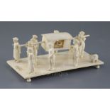 A 19th century Indian carved ivory group of a nobleman being carried in a sedan chair, attended by