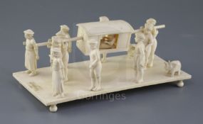 A 19th century Indian carved ivory group of a nobleman being carried in a sedan chair, attended by
