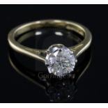 A modern 18ct gold and solitaire diamond ring, the round brilliant cut stone weighing 1.04cts,