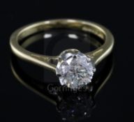 A modern 18ct gold and solitaire diamond ring, the round brilliant cut stone weighing 1.04cts,