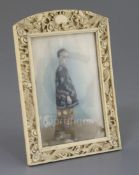 Chinese School, late 19th century, portrait miniature of a boy in an ivory frame, painted with a