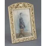 Chinese School, late 19th century, portrait miniature of a boy in an ivory frame, painted with a