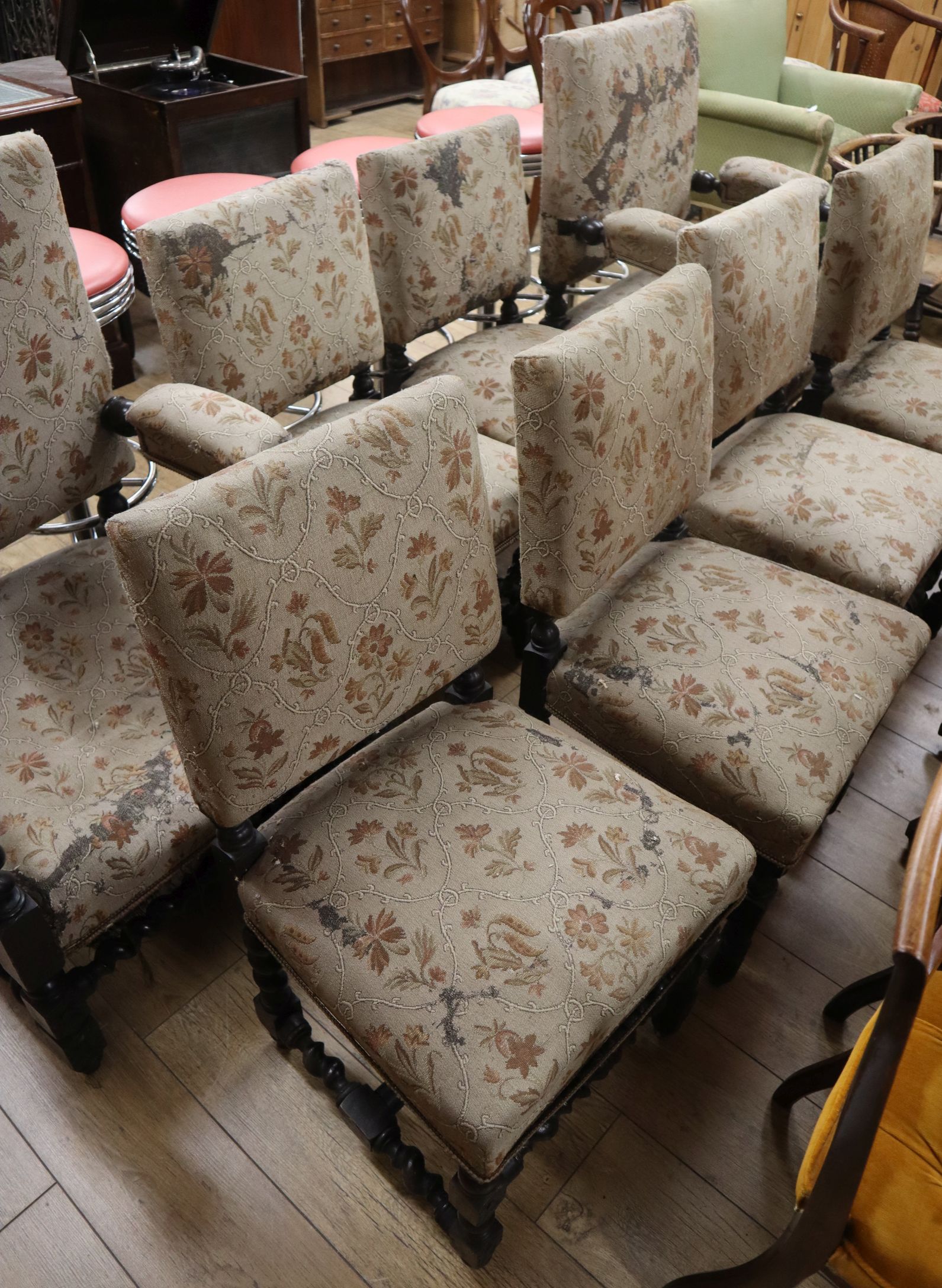 A set of eight Victorian oak upholstered dining chairs (two having arms)