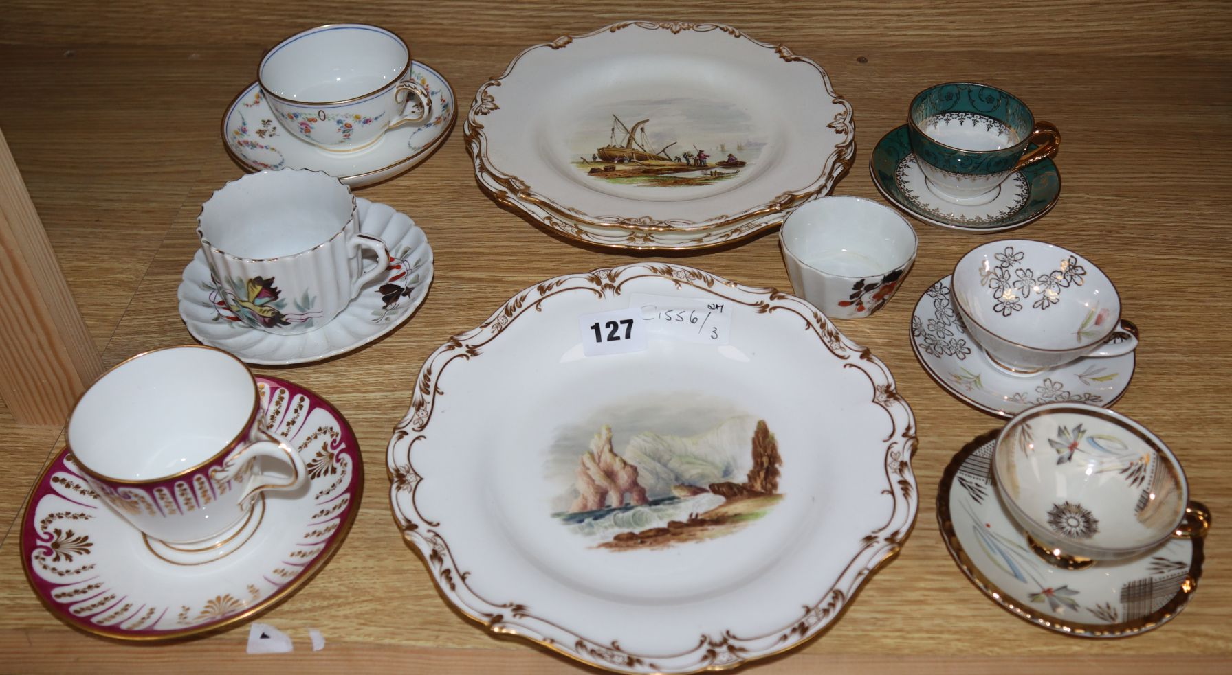 A 19th century plate with a hand painted scene of Freshwater Bay, Isle of Wight, two others and