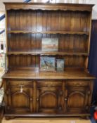 A reproduction oak dresser, with boarded plate rack W.154cm