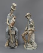 Two Lladro figures, a man with a cat and a man with a violin tallest 44cm