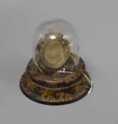 A painted faux tortoiseshell pocket watch stand under glass dome height 12cm