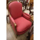 A Louis XVI design walnut armchair upholstered in red fabric
