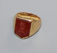 A 19th century yellow metal and carnelian set signet ring, the matrix carved with castle turret