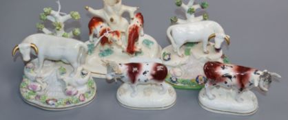 Five Staffordshire porcelain cow figures or groups, c.1830-50, including a pair by Dudson of cows