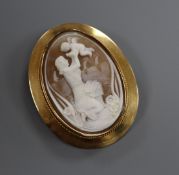 A 750 yellow metal mounted oval cameo brooch, carved with a lady with cherub, signed? on back, (