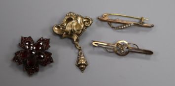 A Victorian garnet set brooch and three other brooches.