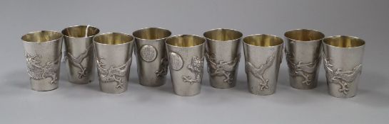A set of nine early 20th century Chinese Export white metal tots, by Zee Wo, each decorated with a