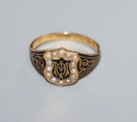 An early 19th century 18ct gold, black enamel and seed pearl set mourning ring, in memory of Mary