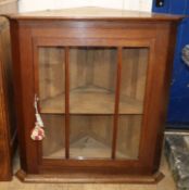 An oak glazed corner cabinet W.83cm