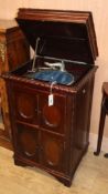 A 1930's gramophone, contained in a carved mahogany cabinet (top split)
