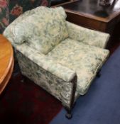 A George II design armchair upholstered in patterned green fabric