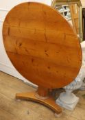 A Victorian circular pine tilt top table W.103cm