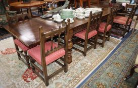 A reproduction oak draw leaf dining table and eight chairs, (two with arms) Table 320cm extended
