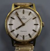 A gentleman's gold plated and steel Omega manual wind wrist watch, on associated flexible strap.