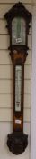 A Victorian carved oak stick barometer by G. I. Lowther, Newcastle on Tyne, in carved oak case