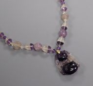 A Chinese amethyst and rock crystal pendant hung from a carved amethyst and rock crystal necklace,