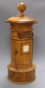 A golden oak pillar box height 63cm