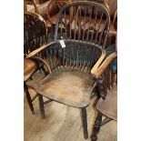 An early 19th century Windsor comb back elbow chair, with traces of original paint