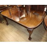 A 1930's Chippendale style carved mahogany extending dining table, on claw and ball feet Extended