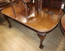 A 1930's Chippendale style carved mahogany extending dining table, on claw and ball feet Extended