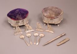 Two silver mounted pin cushions, a set of four George V silver menu holders, four salt spoons,