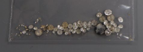A small quantity of loose gemstones including diamonds.