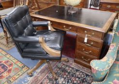 A late Victorian oak pedestal desk, bears Howard and Son stamp and plaque, together with a