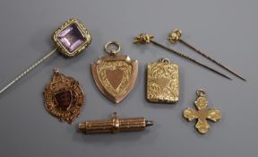 Two 9ct gold watch fobs, a 9ct gold cross pendant, another pendant, a 9ct gold propelling pencil and