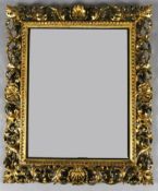 A 19th century Florentine carved and pierced giltwood wall mirror, W.2ft 3in. H.2ft 7in.