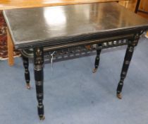 An Edwardian ebonised card table W.94cm