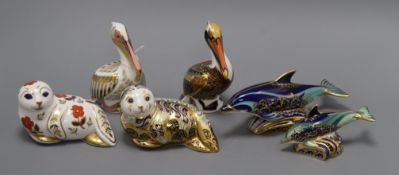 Six Royal Crown Derby paperweights: two seals, two pelicans and two dolphins